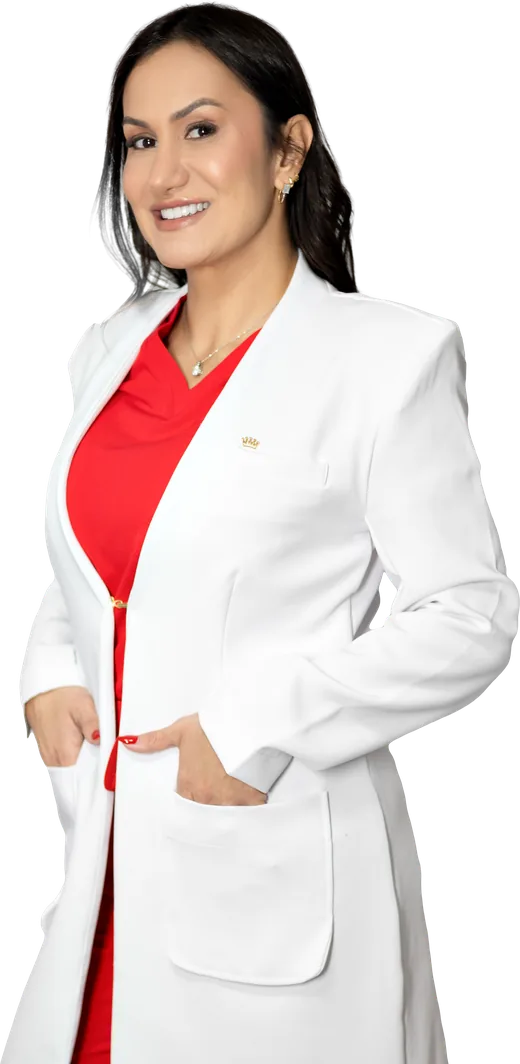 Bianca Lemos in a white coat over red scrubs, smiling